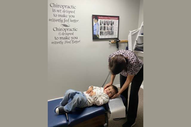A child is being examined by an occupational therapist.