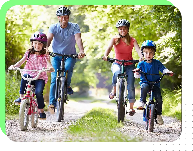 A family riding bikes down the road